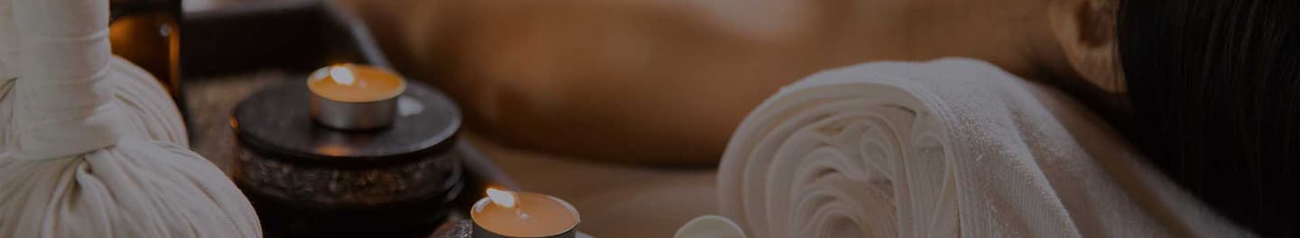 Client relaxing in a spa with candles.