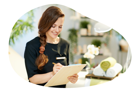 Day spa employee looking at appointment schedule. Day spa employee looking at appointment schedule.