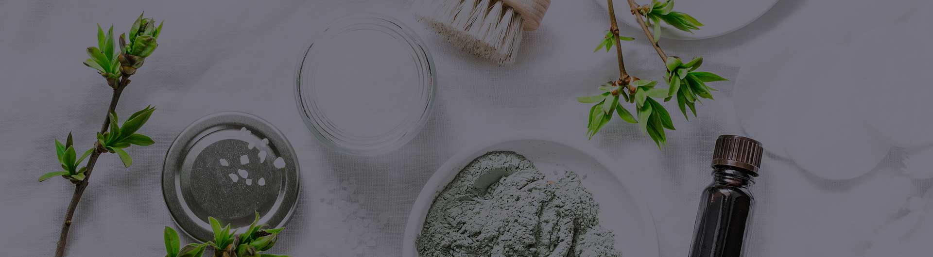 Aromatic oils and salt scrub on a white table.