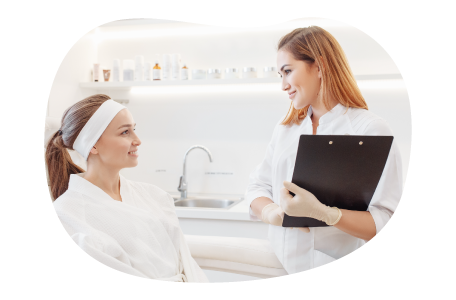 A hair removal specialist meets with a client. A hair removal specialist meets with a client.
