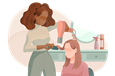 Hairstylist blowdrying a client's hair.