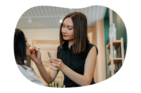 Makeup artist applying makeup onto a client.