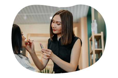 Makeup artist applying makeup onto a client.