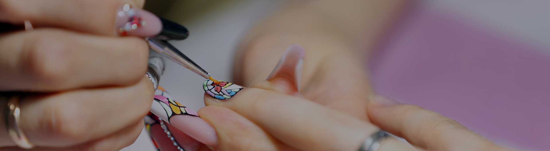 Nail technician painting a client's nails. Nail technician painting a client's nails.