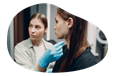 A body piercer prepares a client in a piercing shop.