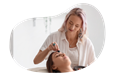 A Reiki practitioner places a healing stone on a client's forehead.
