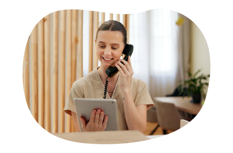 A receptionist at a sauna talks to a client on the phone.