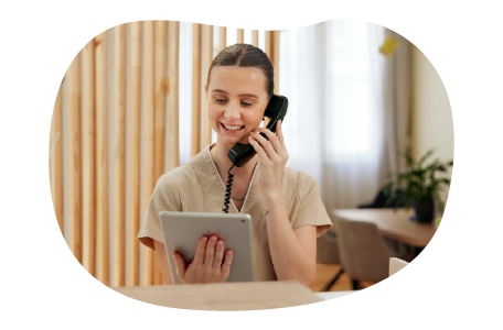 A receptionist at a sauna talks to a client on the phone. A receptionist at a sauna talks to a client on the phone.