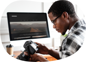 Photographer reviewing photos on a camera.