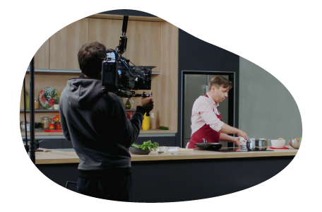 Videographer filming an actor in a scene. Videographer filming an actor in a scene.