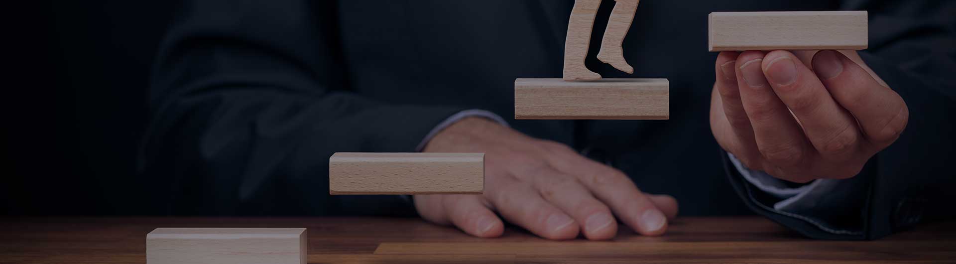 Man climbing stairs up to a blue sky.