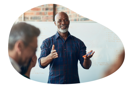 Corporate trainer giving a lecture to employees at a business.