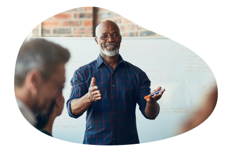 Corporate trainer giving a lecture to employees at a business. Corporate trainer giving a lecture to employees at a business.