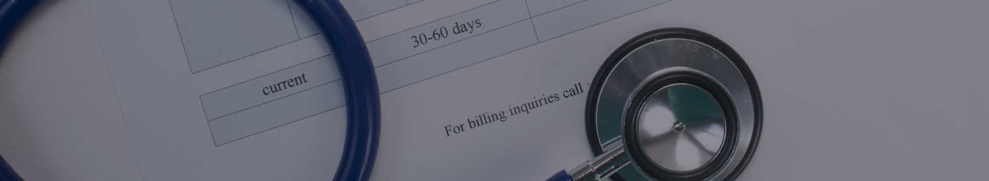 Stethoscope laid over a medical bill.