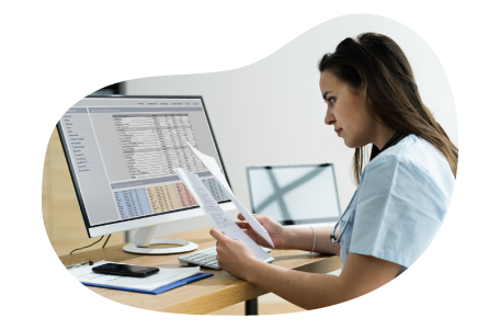 Medical billing professional reviewing invoices. Medical billing professional reviewing invoices.