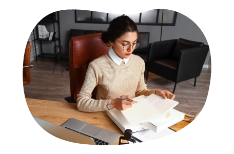 Notary reviewing documentation to be notarized. Notary reviewing documentation to be notarized.