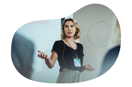 Public speaker giving a lecture in front of a group of people.