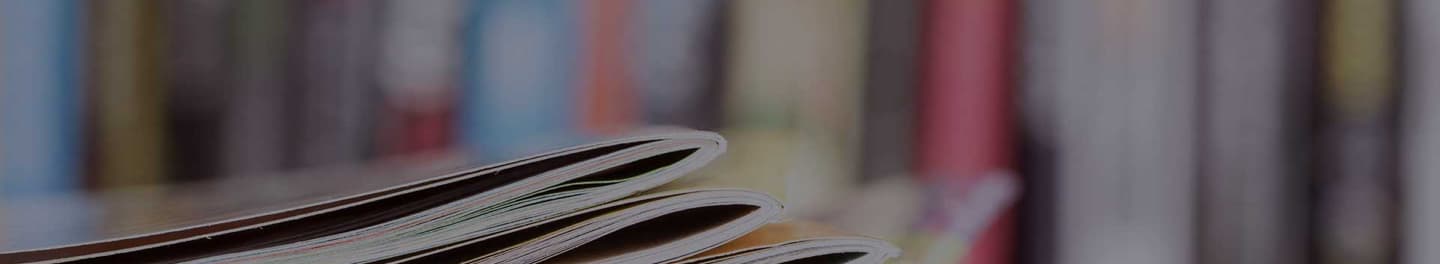 Numerous books on a desk.