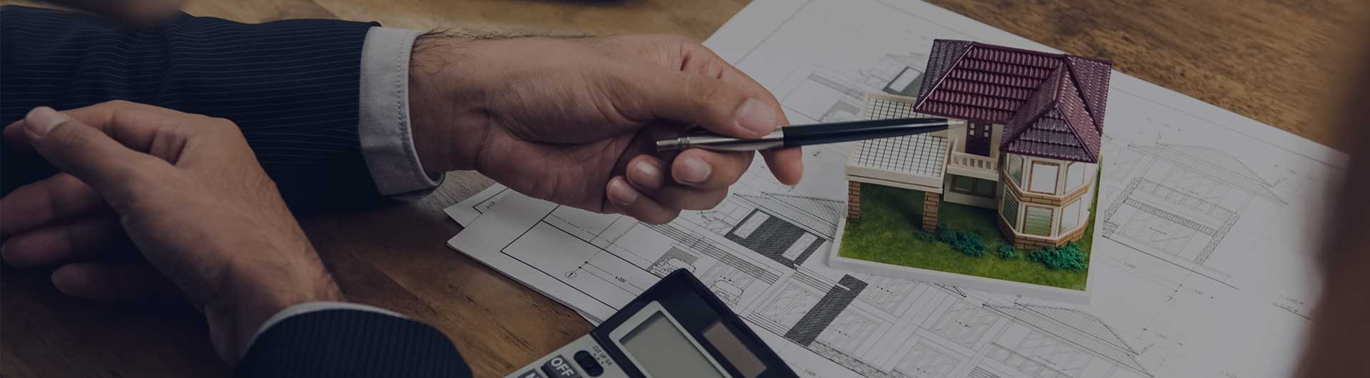 Real estate appraiser with paperwork at his desk 