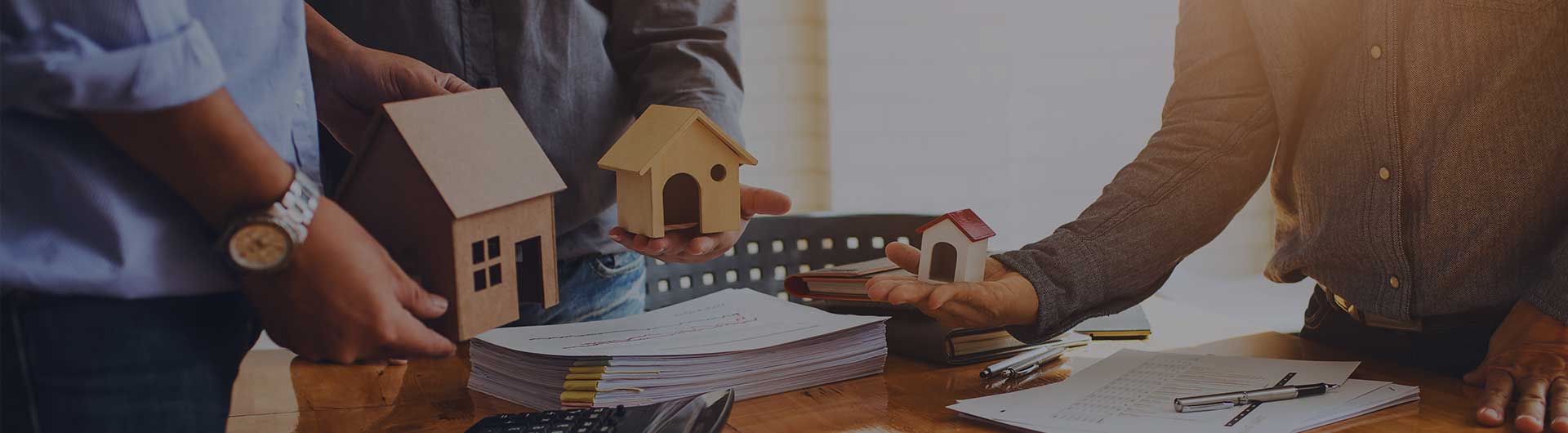 Closing agents with tiny homes over a desk Closing agents with tiny homes over a desk