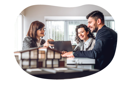 Mortgage broker reviewing housing information at a table with clients. Mortgage broker reviewing housing information at a table with clients.