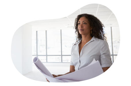 Property manager reviewing the architecture of a building they manage. Property manager reviewing the architecture of a building they manage.