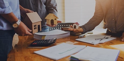 Mortgage broker reviewing paperwork at a desk