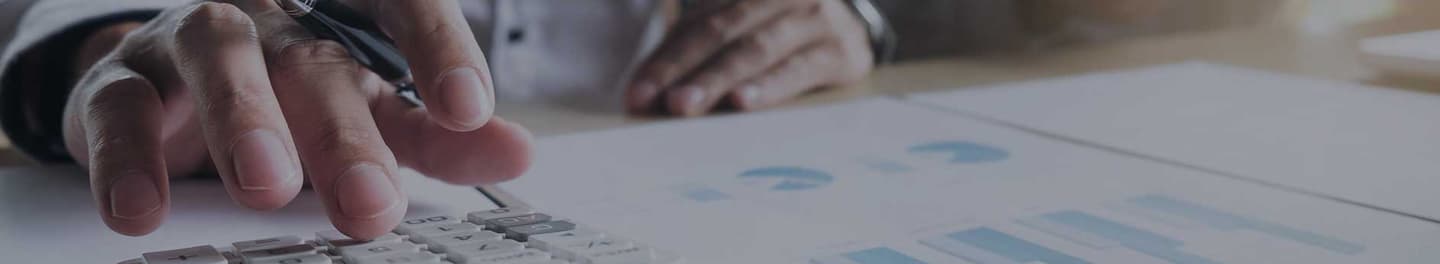 Title abstractor at desk with a calculator