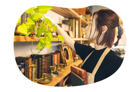 An employee arranging books in an antique shop. An employee arranging books in an antique shop.