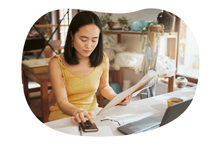 Hobby store employee taking inventory of art supplies on a computer.