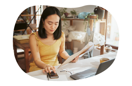 Hobby store employee taking inventory of art supplies on a computer. Hobby store employee taking inventory of art supplies on a computer.