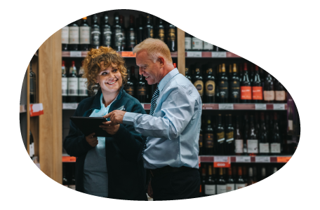 Liquor store salesman showing inventory to a client.