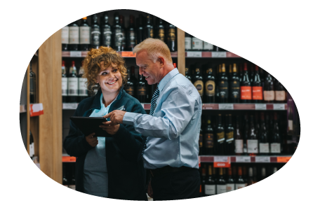 Liquor store salesman showing inventory to a client.