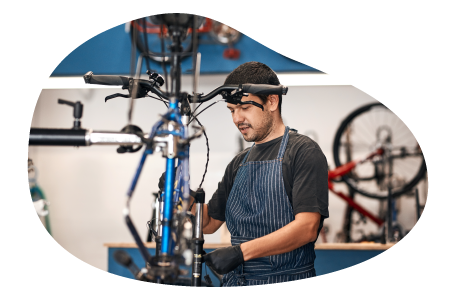 A worker at a bike store assembles a bike.