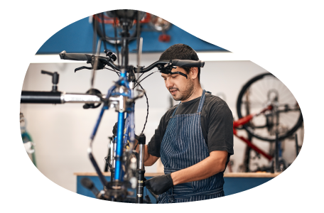A worker at a bike store assembles a bike. A worker at a bike store assembles a bike.