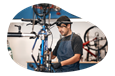 A worker at a bike store assembles a bike.