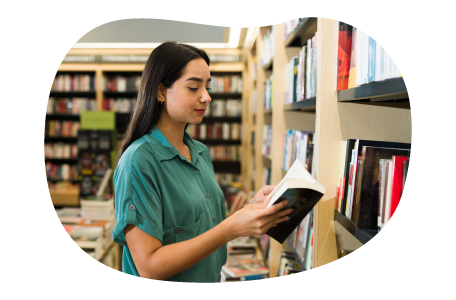 A customer flips through a book at a bookstore.