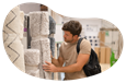 A customer examines a rolled up carpet at a store.
