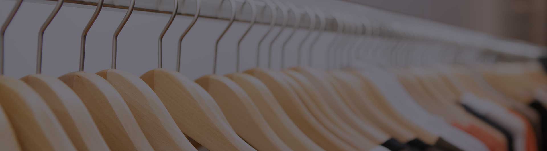 Shirts hanging on a rack in a designer clothing store.