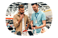 Electronics store employee showing smartphones on display to a customer.