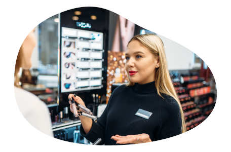 Beauty product salesperson showing accessories on display to a customer. Beauty product salesperson showing accessories on display to a customer.