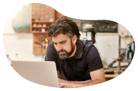 An eBay seller posts a product for sale on their laptop.