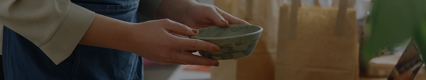 An Etsy seller with a handmade ceramic bowl. An Etsy seller with a handmade ceramic bowl.