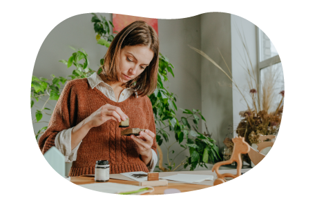 An Etsy seller stamps a handmade craft.