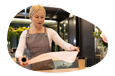 An employee at a gift shop prepares to wrap a gift.