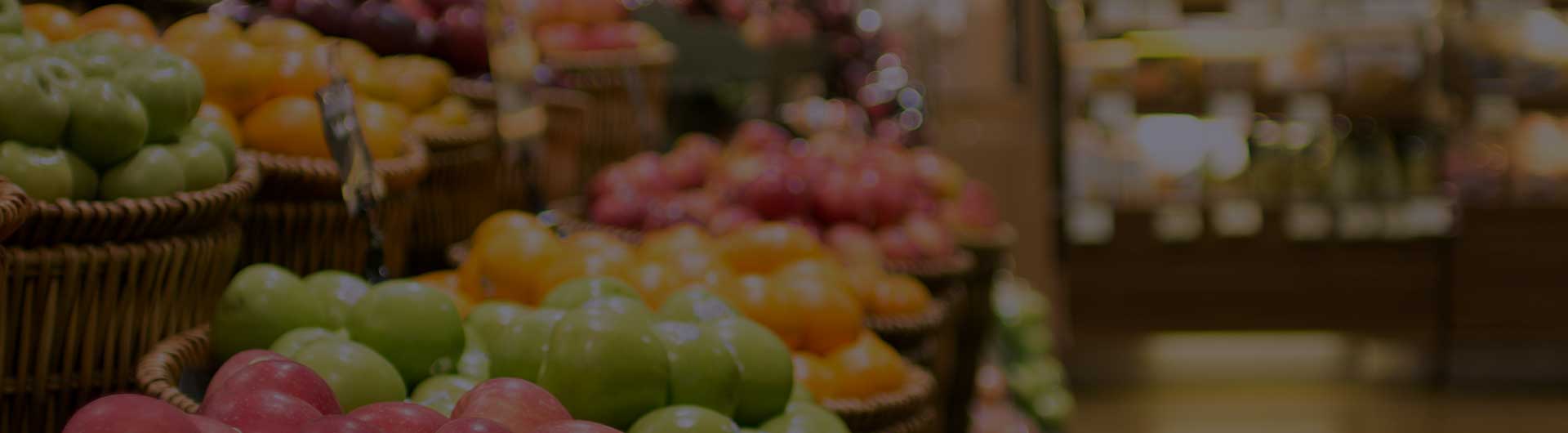 Blurry image of a produce aisle in a grocery store. Blurry image of a produce aisle in a grocery store.