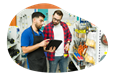 An employee helps a customer find the right item at a hardware store.