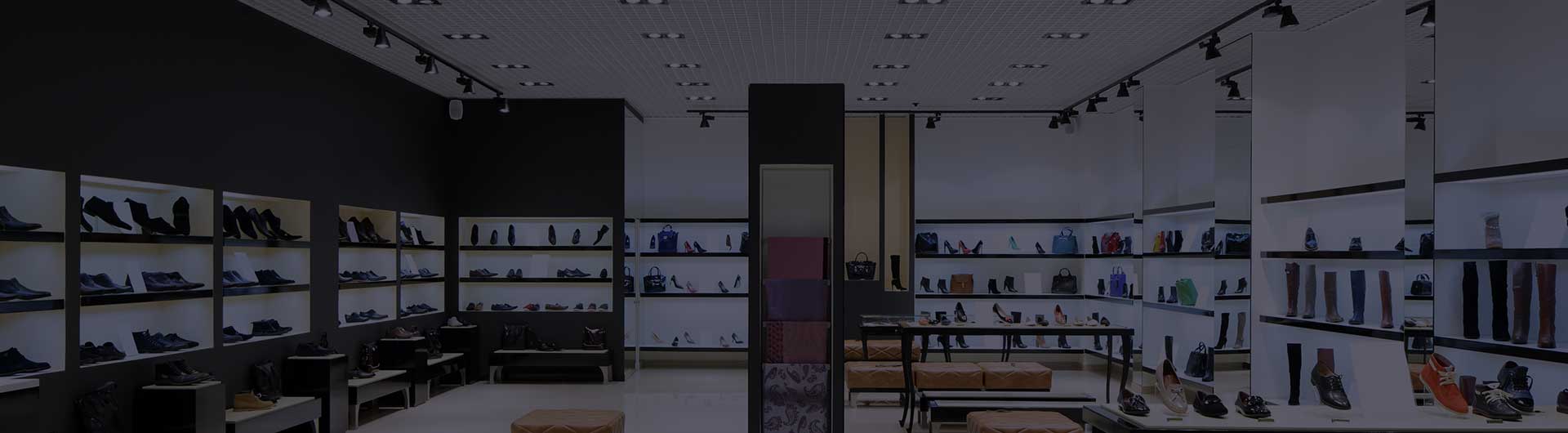 Shoes on racks inside a retail store. Shoes on racks inside a retail store.