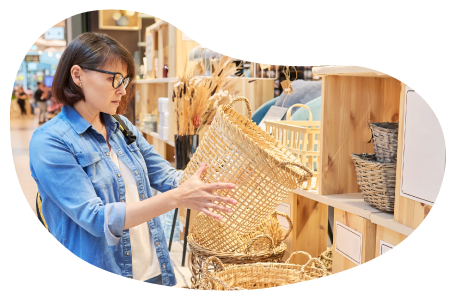 A customer examines a basket at a home decor shop.