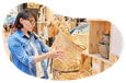 A customer examines a basket at a home decor shop.